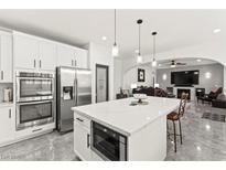 Modern kitchen features stainless steel appliances, white cabinets, and an island with pendant lighting at 366 Rancho La Costa St, Las Vegas, NV 89138
