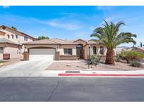 Charming single-story home with desert landscaping, a palm tree, and attached two-car garage at 5600 Blue Peak Ave, Las Vegas, NV 89131