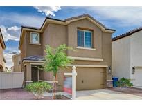 Two-story home featuring a two-car garage, neutral stucco, and a well-maintained front yard at 6231 Portland Treaty Ave, Las Vegas, NV 89122