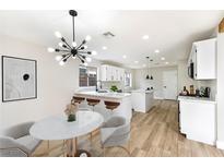 Bright kitchen featuring a large island with seating, modern lighting, and stainless steel appliances at 8113 Bay Springs Dr, Las Vegas, NV 89128