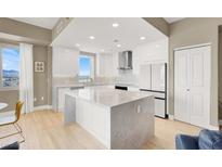 Bright kitchen features sleek white cabinetry, stainless steel appliances, and a large center island at 8255 Las Vegas Blvd # 1422, Las Vegas, NV 89123