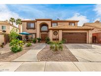 Charming two-story home featuring a tile roof, front yard landscaping and an attached two car garage at 905 Possum Hill St, Henderson, NV 89014