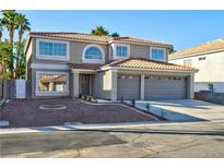 Charming two-story home featuring a three-car garage, desert landscaping, and a classic tile roof at 9541 Summersweet Ct, Las Vegas, NV 89123