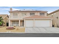Charming two-story home showcasing a cozy balcony, front-facing two-car garage, and tasteful landscaping at 9815 Ramhorn Canyon St, Las Vegas, NV 89183