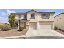 Charming two-story home with a two-car garage and desert landscaping at 10508 Waking Cloud Ave, Las Vegas, NV 89129