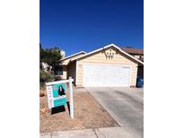 Inviting single-story home with a two-car garage and mature landscaping at 1676 Divinity St, Las Vegas, NV 89142