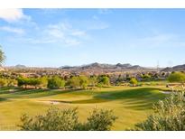 Scenic view of lush golf course with mature trees and mountain views at 21 Avenida Sorrento, Henderson, NV 89011