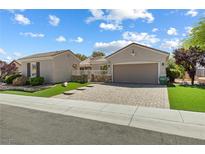 Charming single story home featuring a neatly landscaped front yard and paver driveway at 2164 Sawtooth Mountain Dr, Henderson, NV 89044