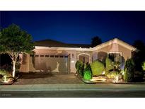 Charming single-story home with manicured landscaping and a spacious two-car garage, illuminated at night at 2312 Indigo Island St, Henderson, NV 89044