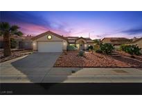 Charming one-story home with low-maintenance desert landscaping and a two-car garage at dusk at 2725 Byron Dr, Las Vegas, NV 89134