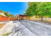 Charming single-story home featuring a spacious front yard with mature trees and covered parking at 4100 Montebello Ave, Las Vegas, NV 89110