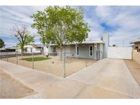 Charming single-story home featuring a gravel yard, chain-link fence, and a private driveway at 419 National St, Henderson, NV 89015