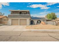 Two-story home featuring a two-car garage, solar panels, and landscaped front yard at 4666 Plata Del Sol Dr, Las Vegas, NV 89121