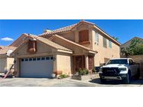 Charming two-story home with a well-maintained front yard and a visible two-car garage, and white truck at 6429 Rosemount Ave, Las Vegas, NV 89156