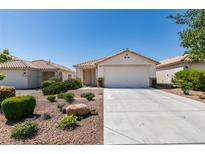 Single story home with a two car garage and low maintenance landscaping at 8877 Perfect Diamond Ct, Las Vegas, NV 89129