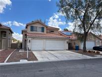 Charming two-story home with a spacious three-car garage and well-maintained front yard at 9004 Dulcimer Ln, Las Vegas, NV 89123