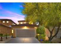 Charming two-story home with a well-maintained front yard and a two-car garage showcasing a suburban feel at 9218 Grassy Weep Ct, Las Vegas, NV 89178