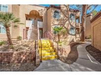 Beautiful condo with a charming courtyard entrance and stairs leading to the upper levels at 9325 W Desert Inn Rd # 120, Las Vegas, NV 89117