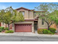 Inviting two-story home featuring a landscaped front yard and a two-car attached garage at 10410 Poplar Park Ave, Las Vegas, NV 89166