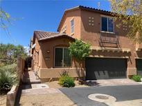 Beautiful stucco home featuring a private two-car garage and landscaped front yard at 1139 Via Partito, Henderson, NV 89052