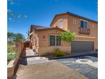 Charming two-story home with a two-car garage, landscaped yard, and a brick walkway to a private fenced entryway at 1139 Via Partito, Henderson, NV 89052