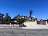 Charming single-story home featuring a well-maintained lawn and desert landscaping, with a two-car garage at 1281 Challenge Ln, Las Vegas, NV 89110