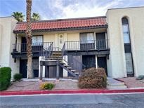 Two-story condo featuring a red tile roof and a well-maintained stucco exterior with black metal railings at 1440 Vegas Valley Dr # 2, Las Vegas, NV 89169