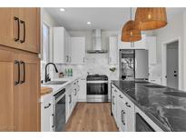 Modern kitchen features stainless steel appliances, white cabinets, and a marble backsplash at 1551 Boundary Peak Way, Las Vegas, NV 89135