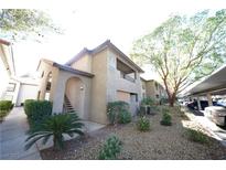 Well-maintained apartment building with mature trees and manicured landscaping offering covered parking at 2606 S Durango Dr # 264, Las Vegas, NV 89117