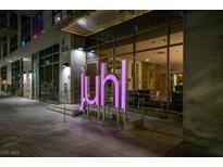 Striking nighttime view of the Juhl building entrance with modern architectural details and illuminated signage at 353 E Bonneville Ave # 1302, Las Vegas, NV 89101