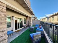 Cozy outdoor patio featuring modern wicker furniture and stylish lighting with a view of the neighborhood at 600 N Carriage Hill Dr # 1082, Las Vegas, NV 89138