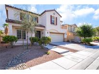 Charming two-story home with a well-manicured front yard and a two-car garage at 7098 Seabirds Pl, North Las Vegas, NV 89084