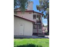 Two-story condo featuring a covered stairwell leading to the entrance at 805 Rock Springs Dr # 101, Las Vegas, NV 89128