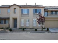 Inviting townhome featuring a neutral color palette, tidy landscaping, and a two-car garage at 8139 Retriever Ave, Las Vegas, NV 89147
