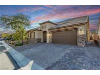 Beautiful single-story home with a stone accent, wide driveway, and manicured landscaping at 8797 Pinley Spring St, Las Vegas, NV 89113