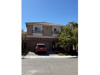 Charming two-story home with a two-car garage and brick accents, complemented by a well-manicured lawn and mature trees at 9823 Belle Marie Ct, Las Vegas, NV 89141