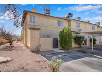 Charming townhome featuring guest parking, mature landscaping, and a secure front entrance gate at , Henderson, NV 89011