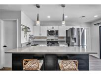 Bright kitchen features stainless steel appliances, quartz counters, and modern pendant lighting at 1025 Willow Tree Dr # B, Las Vegas, NV 89128