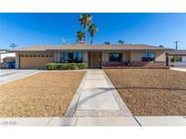 Charming single story home featuring well-maintained landscaping, and attractive desert rock at 1727 Cherokee Ln, Las Vegas, NV 89169