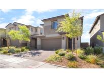 Modern two-story home with a brick driveway, landscaped yard, and neutral color palette at 23 Strada Barbera, Henderson, NV 89011