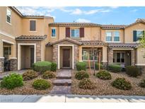 Charming townhome featuring a well-maintained landscaped front yard and inviting entryway at 2871 Tanager Hill St, Henderson, NV 89044