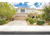 Inviting two-story home with a charming exterior, a well-manicured lawn, and a large two car garage at 3163 Biccari Ave, Henderson, NV 89044