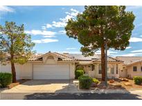 Charming home with solar panels and a well-maintained front yard with mature trees at 3510 Judah Way, Las Vegas, NV 89147