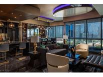 Modern living room with a city view, marble floors, and a stylish bar area, perfect for entertaining at 4575 Dean Martin Dr # 1909, Las Vegas, NV 89103
