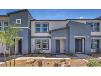 Inviting townhome exterior with modern two-tone paint and low maintenance desert landscaping at 5011 Sage Mesa Ave # Lot 143, Las Vegas, NV 89139