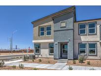 New two-story home featuring modern architecture and neutral color scheme on a clear day at 6104 Aster Garden St # 129, North Las Vegas, NV 89081