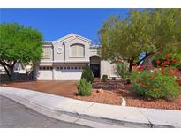 Charming two-story home featuring an attached three-car garage and well-maintained landscaping at 614 Ravenglen Dr, Las Vegas, NV 89123