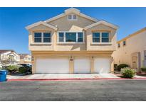 Charming home featuring a three-car garage, well-maintained landscape, and a light beige facade at 6576 Buster Brown Ave # 101, Las Vegas, NV 89122
