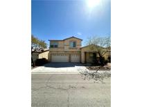 Two-story stucco home with a two-car garage and desert landscaping in front at 7607 Pioneer Ranch Ave, Las Vegas, NV 89113