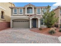 Charming home featuring manicured landscaping, a paved driveway, and a two-car garage at 8176 Duncan Peak Ct, Las Vegas, NV 89139